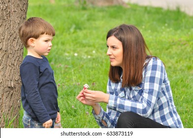Happy Mom And Son Play In The Park In Spring Mother Talking To Her Son Happy Mom And Son Play In The Park In Spring Mother Talking To Her Son