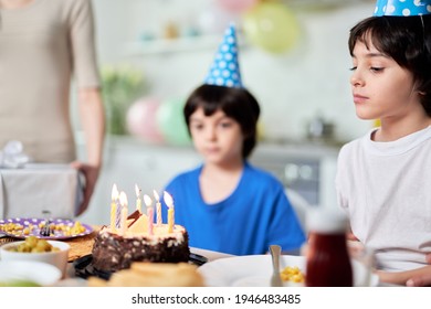 Happy Moment. Close Up Of Little Hispanic Boy Looking At Birthday Cake, Making A Wish While Getting Ready For Blowing Candles. Latin Family Celebrating Birthday Together At Home