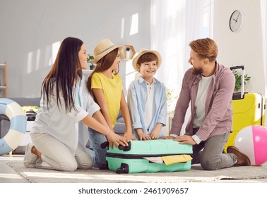 Happy moment when parents and children close packed suitcase together before summer trip. Father, mother, son and daughter sitting at home in living room ready to go on summer vacation to resort. - Powered by Shutterstock