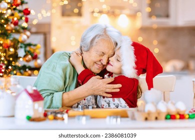 Happy moments in the family and time spent together with relatives on the eve of Christmas. Festive pastries and the aroma of Christmas. Grandma and her granddaughter are happy to cook cookies  - Powered by Shutterstock