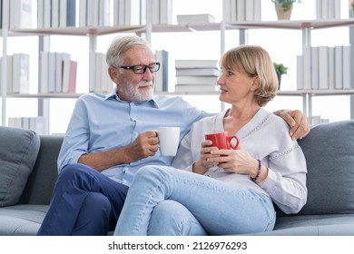 Happy Morning, Caucasians Senior Lover Couple Family. Mature, Adult Retired Man, Woman Drinking Coffee, Tea Together, Embracing, Hugging On Sofa, Couch At Home. Pleasure Husband And Wife Lifestyle.