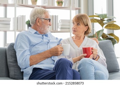 Happy Morning, Caucasians Senior Lover Couple Family. Mature, Adult Retired Man, Woman Drinking Coffee, Tea Together, Embracing, Hugging On Sofa, Couch At Home. Pleasure Husband And Wife Lifestyle.