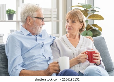 Happy Morning, Caucasians Senior Lover Couple Family. Mature, Adult Retired Man, Woman Drinking Coffee, Tea Together, Embracing, Hugging On Sofa, Couch At Home. Pleasure Husband And Wife Lifestyle.