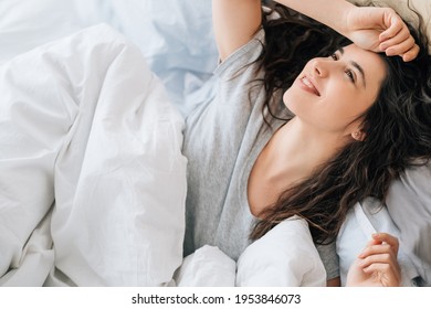 Happy Morning. Sunday Relaxation. Fresh Start. Satisfied Inspired Daydreaming Brunette Woman Enjoying Rest Alone In White Cozy Bed Smiling.