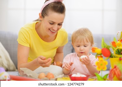 Happy Mother And Baby Eating Easter Eggs