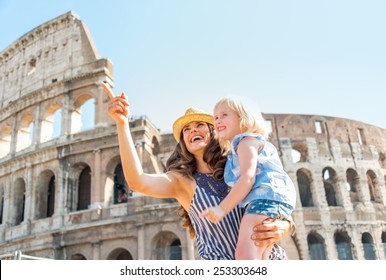 Happy Mother And Baby Girl Sightseeing Near Colosseum In Rome, Italy