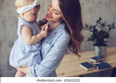 Happy Mother And Baby Playing At Home In Bedroom. Cozy Family Lifestyle In Modern Scandinavian Interior. 