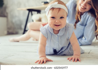 Happy Mother And Baby Playing At Home In Bedroom. Cozy Family Lifestyle In Modern Scandinavian Interior. 