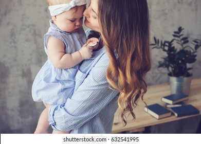 Happy Mother And Baby Playing At Home In Bedroom. Cozy Family Lifestyle In Modern Scandinavian Interior. 