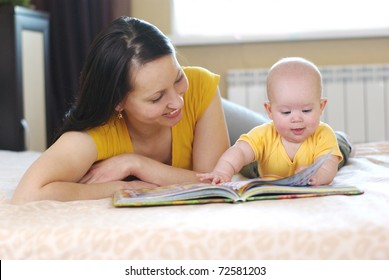 Happy Mother With Baby Reading Book
