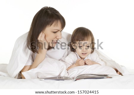 happy mother with baby reading book