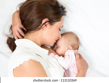 happy mother breast feeding her baby infant
