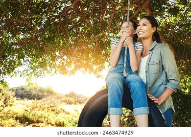 Happy, mother and child on swing outdoor for bonding and play fun game together in nature. Smile, mom and push girl in playground on tire at park for love, care and family holiday on summer vacation - Powered by Shutterstock