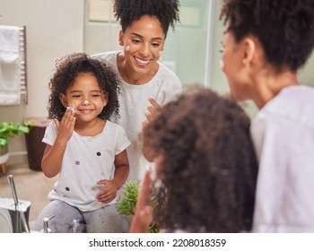 Happy, mother and child with skincare cream in morning routine together for clean and healthy face at home. Smile, fun and beauty of mom in wellness with her baby girl applying lotion to facial skin - Powered by Shutterstock