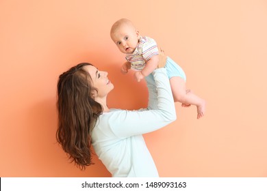 Happy Mother And Cute Little Baby On Color Background