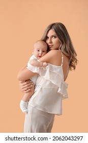 Happy Mother With Cute Little Baby On Color Background