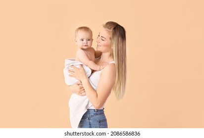 Happy Mother With Cute Little Baby On Color Background