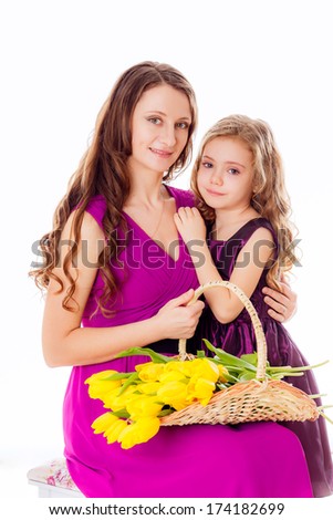 happy mother and daughter with basket of yellow tulips. March 8, International Women's day, valentine's day, mother's day