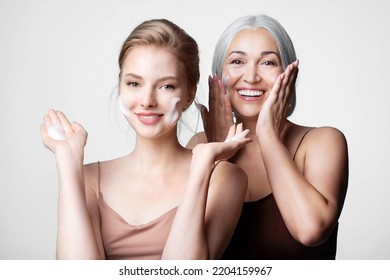 Happy mother and daughter of different ages take care of their skin   washing faces by cleansing cosmetics product. Skincare routine - Powered by Shutterstock