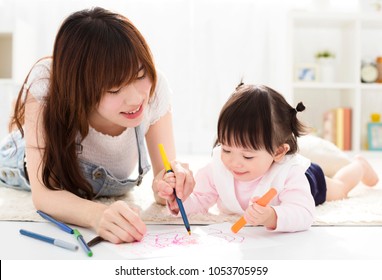 happy Mother and daughter drawing together