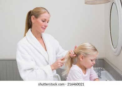 Happy Mother And Daughter Getting Ready At Home In The Bathroom