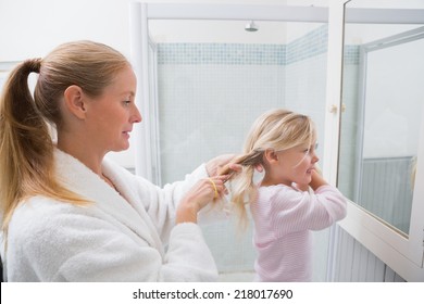 Happy Mother And Daughter Getting Ready At Home In The Bathroom