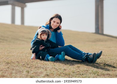 Happy Mother And Daughter Having Fun Outdoors. Mom And Toddler Spending Quality Time Outside In Nature
