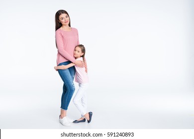 Happy Mother And Daughter Hugging And Smiling At Camera Isolated On White