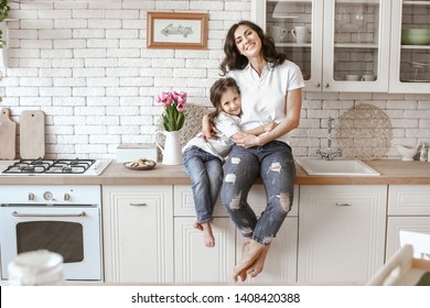 Happy mother with daughter in kitchen at home - Shutterstock ID 1408420388