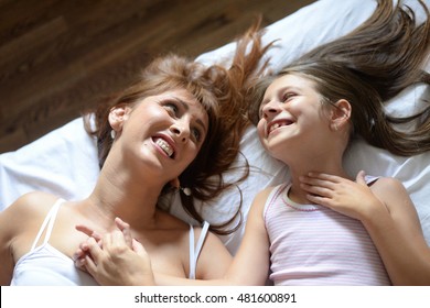 Happy mother and daughter on the bed - Shutterstock ID 481600891