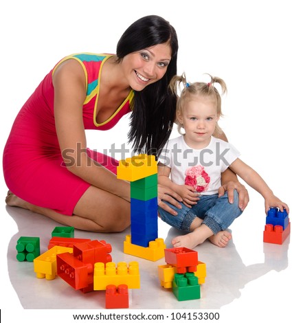 Happy Mother with Daughter playing with blocks. Isolated on a white background.