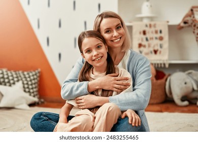 A happy mother and daughter share a joyful moment at home, creating a loving and cozy atmosphere filled with affection. Their bond exudes warmth and happiness - Powered by Shutterstock