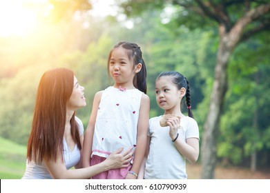 Happy Mother And Daughters In The Park, Asian Family Outdoor Lifestyle, Morning With Sun Flare.