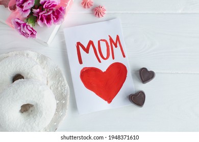 Happy Mother Day Card. I Love Mom. Breakfast, Donat, Carnation Gift And A Card Hand Made By The Child For Mom In Mothers Day.