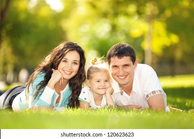 Happy mother, father and daughter in the park - Powered by Shutterstock