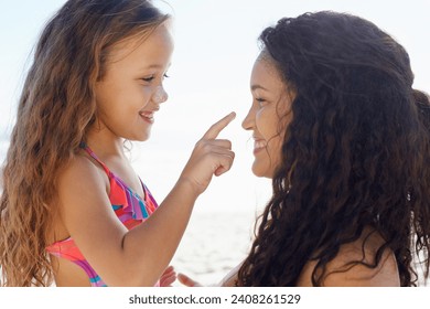 Happy mother, girl and touching nose at beach for love, care or support for child or daughter in nature. Mom and cute young kid smile for poke, feel or sunscreen at ocean or outdoor sea by the coast - Powered by Shutterstock