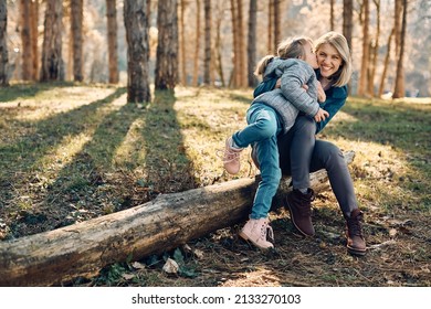 Happy Mother Having Fun While Daughter Is Kissing Her In The Park. Copy Space.