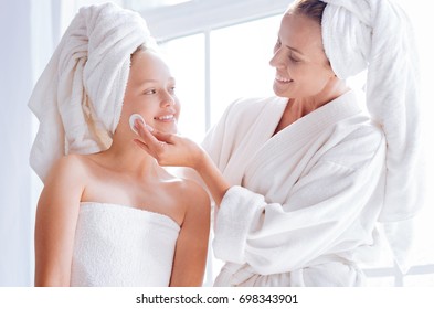 Happy Mother Helping Her Daughter To Clean Face