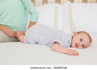 Happy mother with her baby boy at home in bedroom - Shutterstock ID 289406768