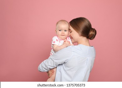 Happy Mother With Her Baby On Color Background. Space For Text