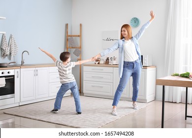 Happy mother and her little son dancing in kitchen - Powered by Shutterstock