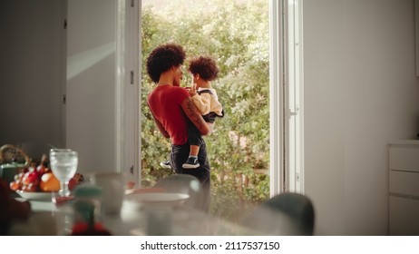 Happy Mother Holding Adorable Baby Boy, Playing, Having Fun At Modern Home Living Room. Latina Female Holding Toddler Child On Her Arms. Concept Of Childhood, New Life, Parenthood.