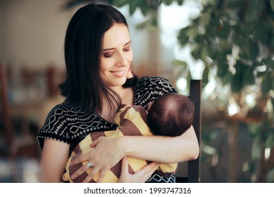 Happy Mother Holding Her Adorable Newborn Baby. Mom Hugging Her Infant Sitting In A Restaurant Watching It Sleep.
