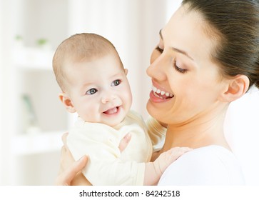 Happy Mother Holding Her Baby