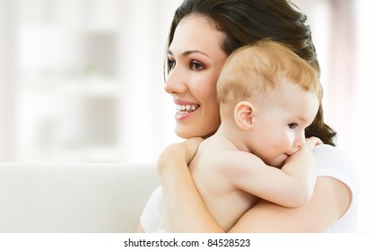 Happy Mother Holding Her Baby