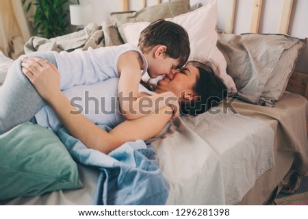 Similar – Little girl playing with boy over the bed