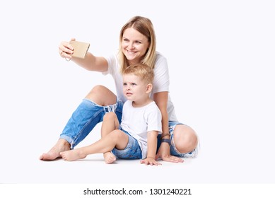 Happy Mother Laughing Taking Selfie With Little Son On Smartphone, Smiling Single Mom And Cute Adopted Boy Playing Making Photo Posing For Self Portrait, Mommy And Kid Watching Video On Cell 