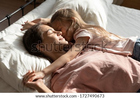 Similar – Little girl playing with boy over the bed