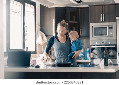 Happy mother and little infant baby boy together making pancakes for breakfast in domestic kitchen. Family, lifestyle, domestic life, food, healthy eating and people concept - Powered by Shutterstock