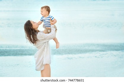 Happy Mother With Little Son On Beach